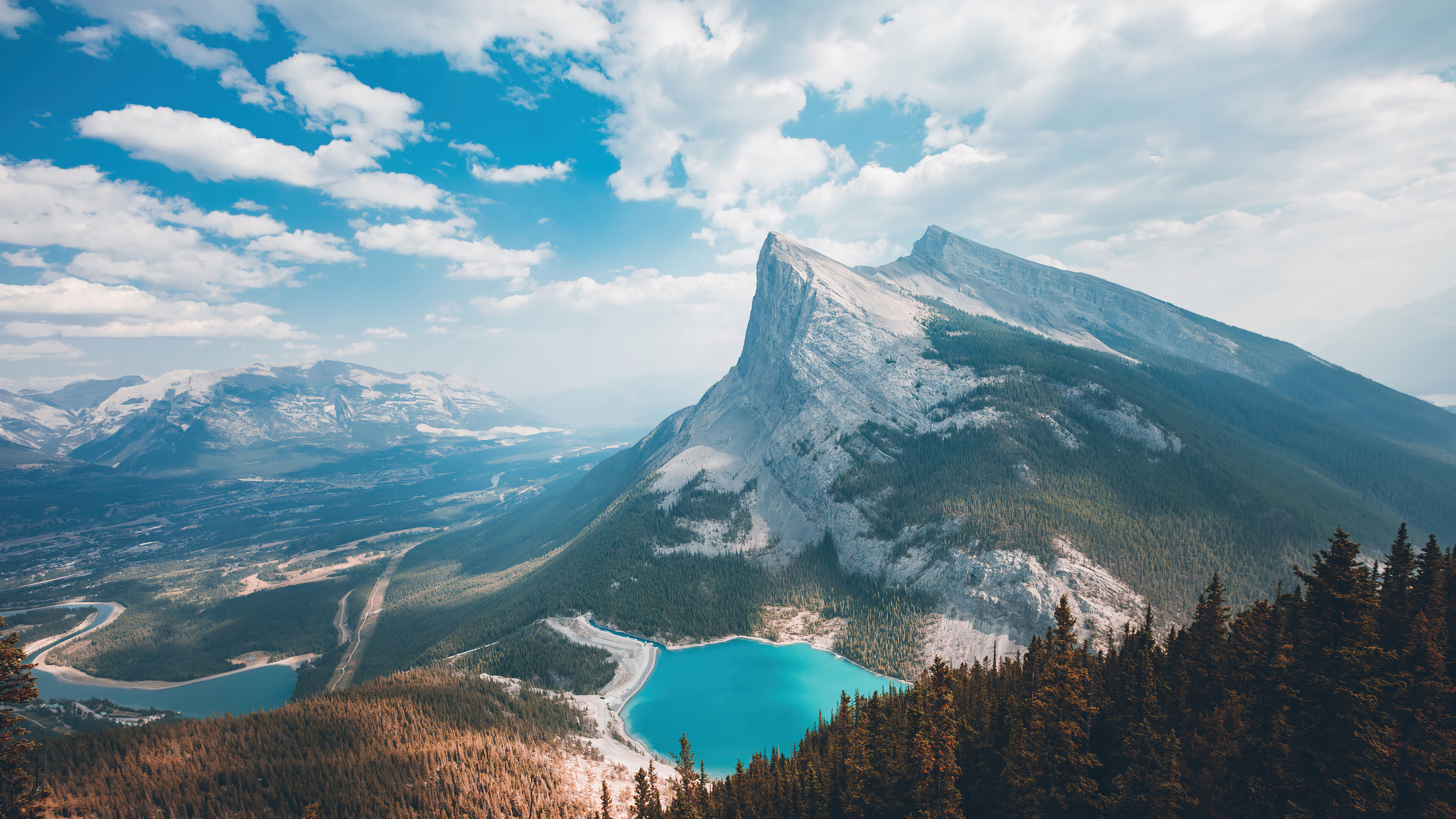 Immerse yourself in the beauty of nature with this stunning 4K wallpaper featuring a serene mountain clouds scenery amidst the forest. The clouds add a beautiful and dramatic element to the wallpaper, while the forest and trees add a touch of serenity and calmness.