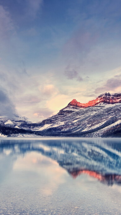 Immerse yourself in the serene beauty of Bow Lake in the Canadian Rockies with this stunning 4K wallpaper. The glacial lake, nestled amidst the rugged Rocky Mountains, offers a tranquil and scenic escape. Perfect for travelers and those seeking a desktop background that captures the natural tranquility and mountainous wonder of this Canadian gem.