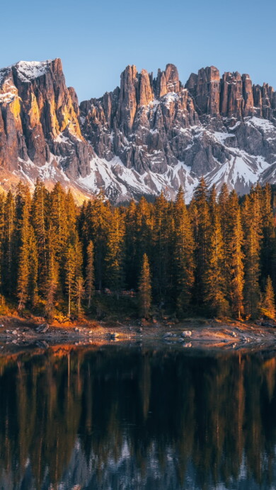 Immerse yourself in the serene beauty of Karersee Lake in Italy's Dolomites with this mesmerizing 4K wallpaper. The alpine lake, surrounded by the stunning landscape of South Tyrol, offers a tranquil and scenic escape. Perfect for travelers and those seeking a desktop background that captures the natural tranquility and alpine wonder of this Italian gem.