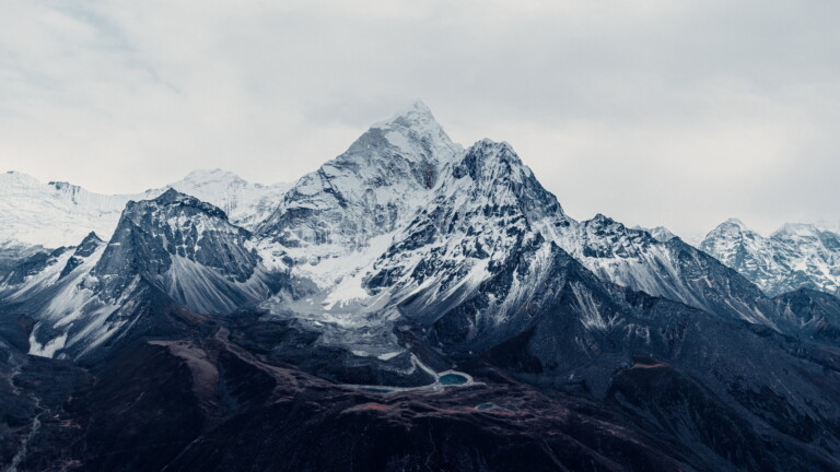 Immerse yourself in the majesty of Mount Everest, the world's tallest mountain, with this breathtaking 4K wallpaper. Located in the Himalayas of Nepal, this iconic peak is a symbol of outdoor adventure and natural wonder. Perfect for travelers and those seeking a desktop background that captures the awe-inspiring beauty of the world's highest mountain.