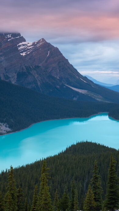 Immerse yourself in the serene beauty of Peyto Lake and the surrounding mountains in Alberta, Canada, with this captivating 4K wallpaper. The tranquil alpine landscape of Banff National Park offers a scenic and peaceful escape. Perfect for travelers and those seeking a desktop background that captures the natural tranquility and rugged beauty of this iconic Canadian destination.