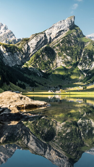 Immerse yourself in the serene beauty of Seealpsee Lake in the Appenzell Alps of Switzerland with this captivating 4K wallpaper. The alpine lake, nestled amidst the stunning Swiss landscape, offers a tranquil and scenic escape. Perfect for travelers and those seeking a desktop background that captures the natural tranquility and alpine wonder of this Swiss gem.