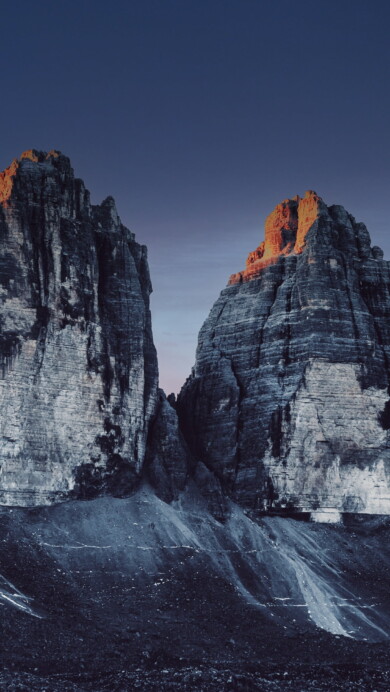 Immerse yourself in the breathtaking beauty of the Three Peaks of Lavaredo in Italy's Dolomites with this captivating 4K wallpaper. These iconic alpine peaks and their rugged landscape create a tranquil and scenic escape. Perfect for travelers and those seeking a desktop background that captures the natural wonder and serenity of these famous mountains.