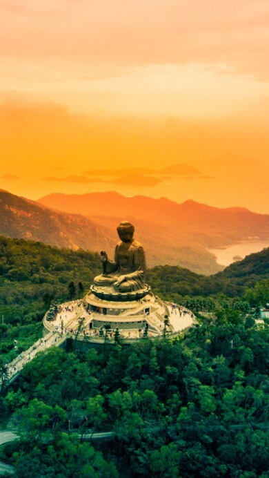 Experience the spiritual serenity of the Tian Tan Buddha statue in Hong Kong with this exquisite 4K wallpaper. This iconic religious landmark on Lantau Island stands as a symbol of Buddhism's cultural heritage. Perfect for those seeking a peaceful and spiritual desktop background, showcasing the statue's serene presence.