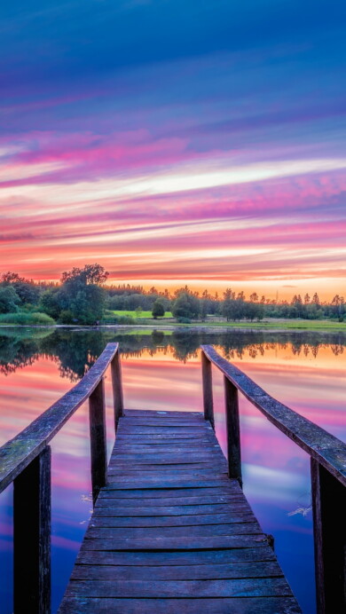 Immerse yourself in the serene beauty of a twilight scene at the dock with this captivating 4K wallpaper. The tranquil waterfront setting bathed in the soft evening light creates a sense of tranquility and peace. Ideal for those who appreciate the beauty of nature and a calming scenic view as a desktop background.