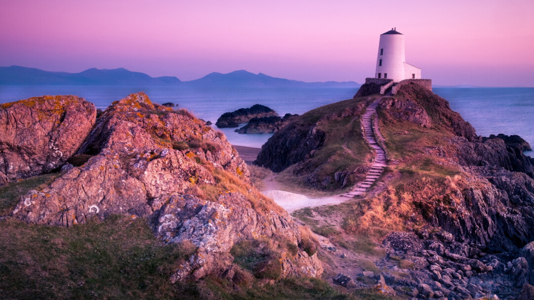 Experience the coastal charm of Twr Mawr Lighthouse in Wales with this exquisite 4K wallpaper. The iconic maritime landmark on Anglesey Island is beautifully captured, offering a tranquil and scenic view that's perfect for travel enthusiasts. Enjoy the architectural beauty against the backdrop of the British Isles as your desktop background.
