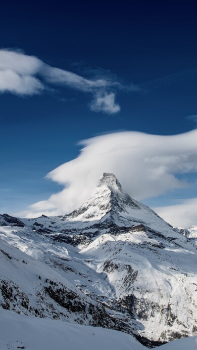 Witness the iconic beauty of Matterhorn Mountain's peak with this magnificent 4K wallpaper. Set against the backdrop of the Swiss Alps, it's an excellent choice for your high-resolution desktop background.