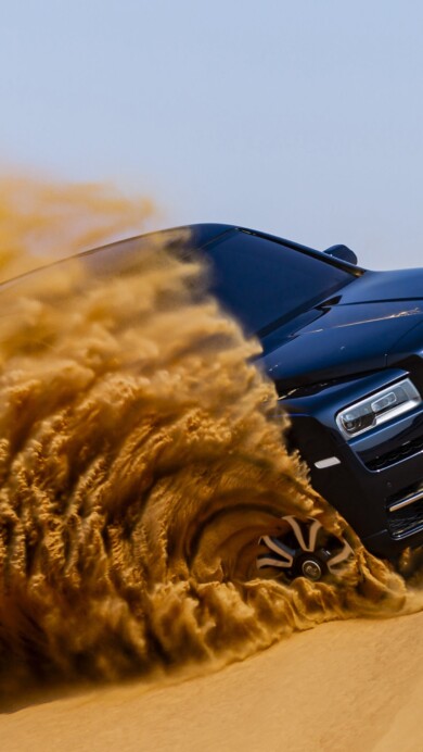 A luxurious 4K wallpaper featuring the Rolls-Royce Cullinan in a breathtaking desert setting. This high-resolution image captures the opulence of the iconic luxury SUV against the expansive desert landscape, creating a visually striking and sophisticated backdrop for desktop or mobile displays.