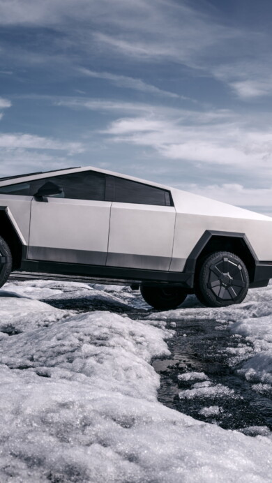 A striking 4K wallpaper capturing the Tesla Cybertruck amidst a pristine snow-covered landscape. The sleek lines of the electric vehicle contrast beautifully with the snowy surroundings, creating a futuristic and captivating scene.