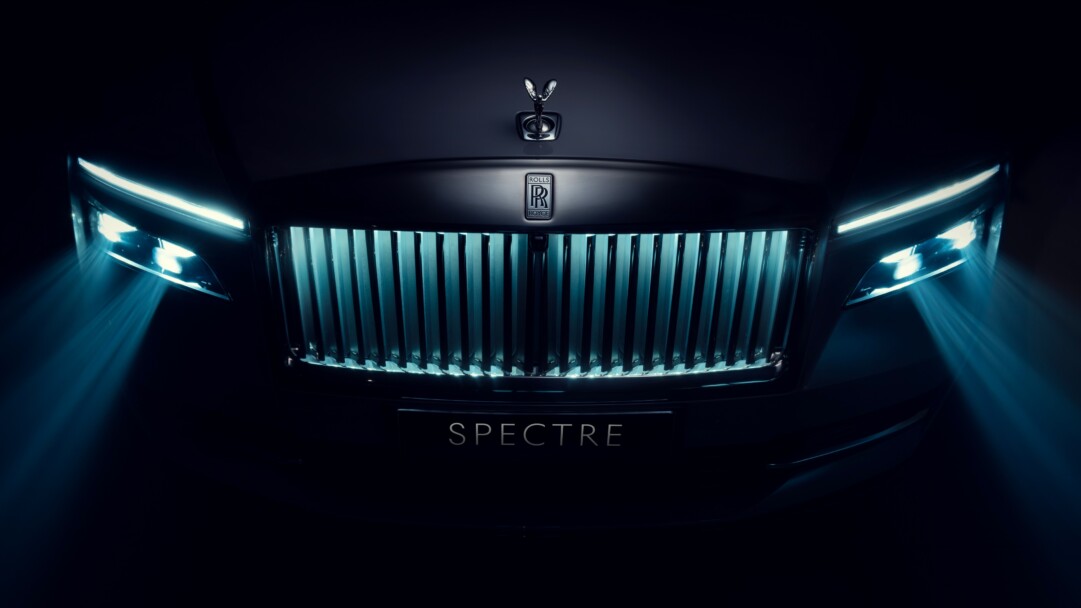 A luxurious 4K wallpaper featuring the Rolls-Royce Spectre, an epitome of automotive elegance. The high-resolution image showcases the sleek design and opulence of this luxury car, making it an ideal choice for your desktop or mobile background.