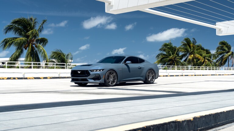 A stunning 4K wallpaper featuring a Ford Mustang GT outdoors, showcasing its sleek and powerful design. The high-resolution image captures the iconic sports car against a scenic backdrop, perfect for enhancing your desktop or mobile screen.