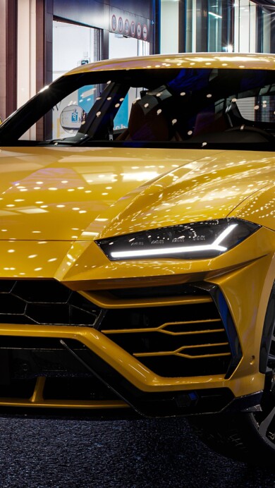 A breathtaking 4K wallpaper showcasing the Lamborghini Urus Super SUV in striking detail. The high-performance luxury SUV is captured in a dynamic setting, highlighting its sleek design and powerful presence, perfect for automotive enthusiasts.